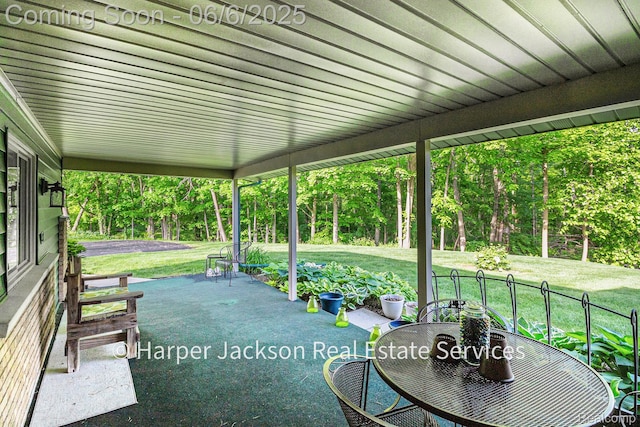 2210 Brookhaven Dr, Flint, MI 48507 - view of patio featuring outdoor dining area and view of scattered trees