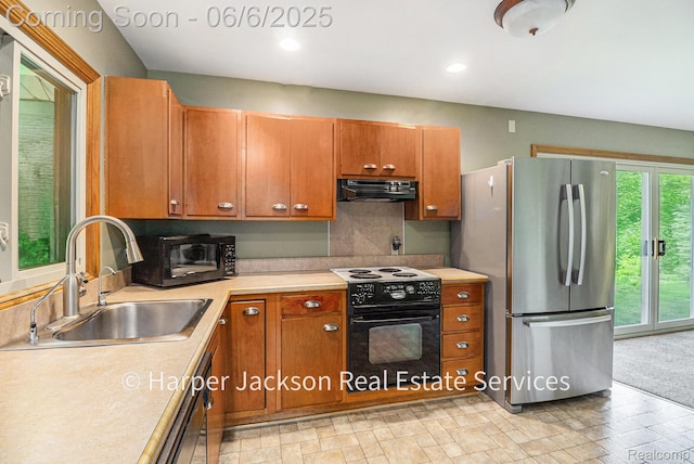 2210 Brookhaven Dr, Flint, MI 48507 - kitchen featuring range with electric cooktop, freestanding refrigerator, under cabinet range hood, a sink, and light countertops