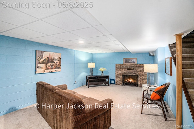 2210 Brookhaven Dr, Flint, MI 48507 - carpeted living area with stairs, a brick fireplace, and a drop ceiling