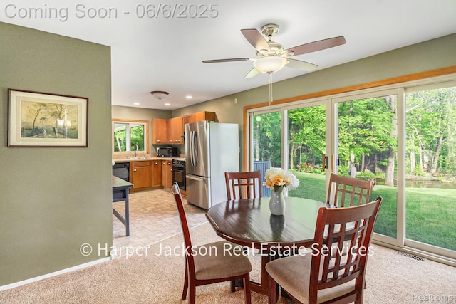 2210 Brookhaven Dr, Flint, MI 48507 - dining room with a ceiling fan, light carpet, and baseboards