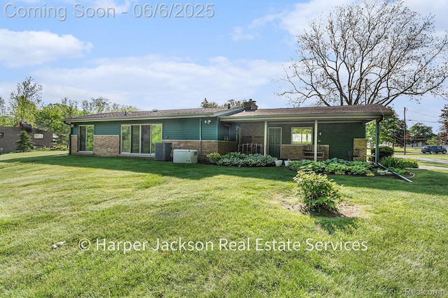 2210 Brookhaven Dr, Flint, MI 48507 - back of property featuring a lawn, brick siding, central AC unit, and a chimney