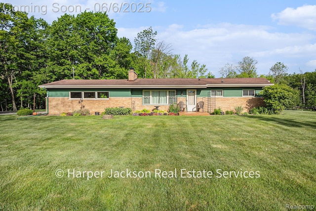 2210 Brookhaven Dr, Flint, MI 48507 - view of front facade featuring brick siding, a chimney, and a front lawn