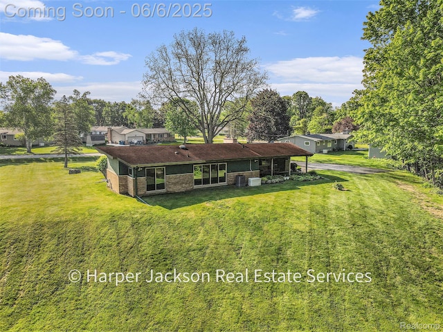 2210 Brookhaven Dr, Flint, MI 48507 - rear view of house with brick siding, a yard, cooling unit, and a chimney
