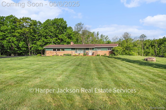 2210 Brookhaven Dr, Flint, MI 48507 - view of front of house with a front lawn and a chimney