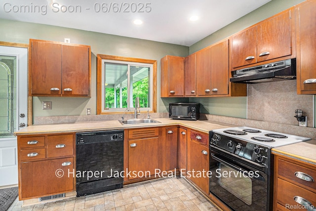 2210 Brookhaven Dr, Flint, MI 48507 - kitchen with black appliances, under cabinet range hood, a sink, light countertops, and recessed lighting