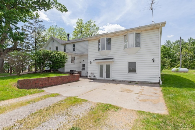 4460 Munger Rd, Tipton, MI 49287 - back of house featuring french doors, a patio, a lawn, and driveway