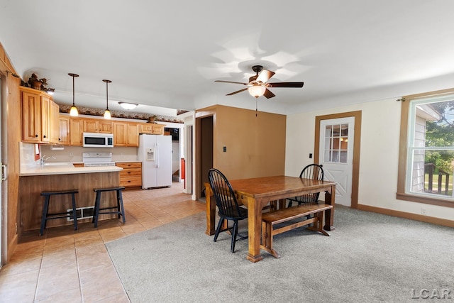 4460 Munger Rd, Tipton, MI 49287 - dining space featuring ceiling fan, light tile patterned floors, and baseboards