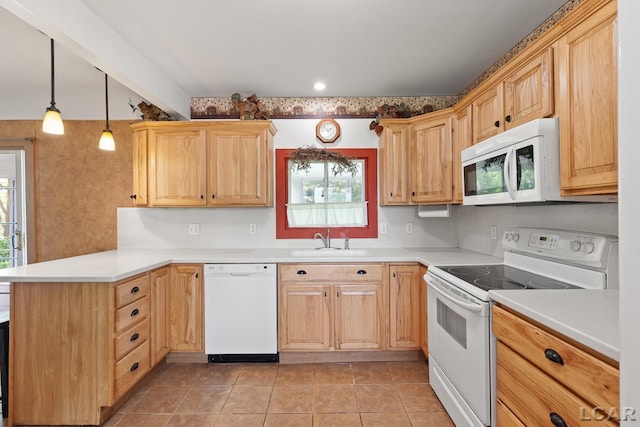4460 Munger Rd, Tipton, MI 49287 - kitchen with white appliances, a peninsula, a sink, and healthy amount of natural light