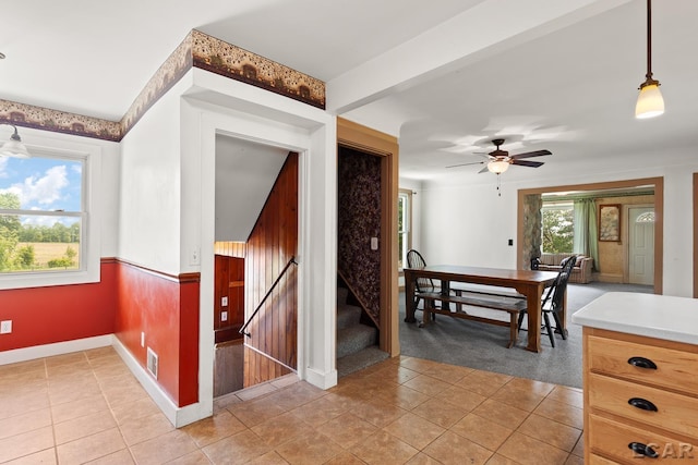 4460 Munger Rd, Tipton, MI 49287 - interior space featuring ceiling fan, baseboards, light tile patterned floors, and stairway