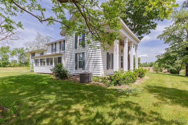 4460 Munger Rd, Tipton, MI 49287 - view of side of home featuring central AC and a yard