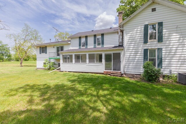 4460 Munger Rd, Tipton, MI 49287 - back of property featuring a chimney, entry steps, a yard, and central air condition unit