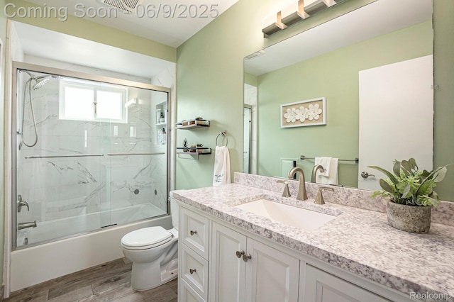 16362 Glenfield Dr, Macomb, MI 48044 - full bathroom featuring toilet, vanity, wood finished floors, and enclosed tub / shower combo