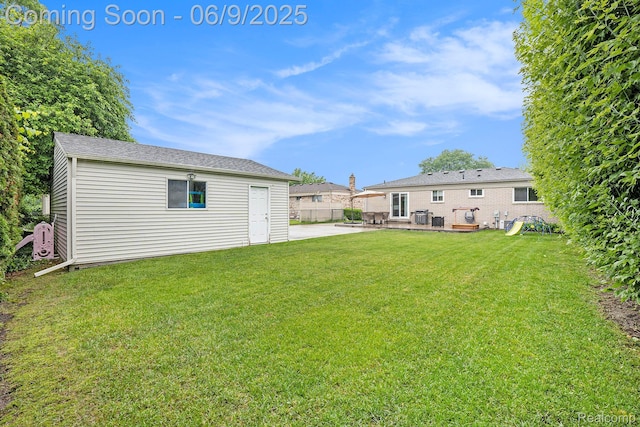 16362 Glenfield Dr, Macomb, MI 48044 - view of grassy yard with a patio area and an outdoor structure