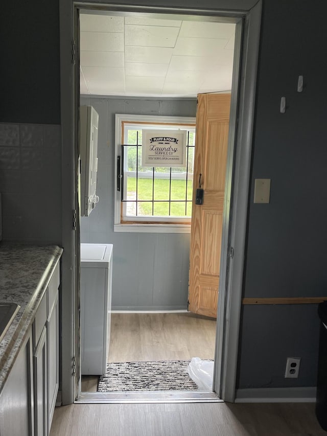 35511 Beverly Rd, Romulus, MI 48174 - doorway featuring wood finished floors and washer / clothes dryer