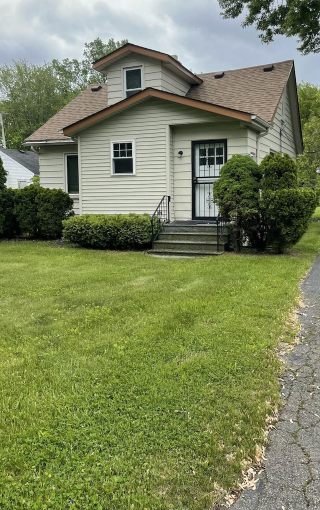 35511 Beverly Rd, Romulus, MI 48174 - bungalow with roof with shingles, a front yard, and entry steps