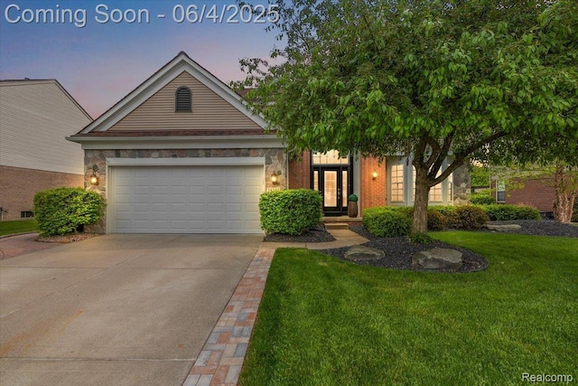 54502 Isle Royale Ave, Macomb, MI 48042 - view of front of house featuring concrete driveway, a front yard, stone siding, and a garage