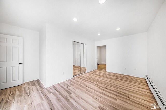 2930 Spielman Rd, Adrian, MI 49221 - empty room with baseboard heating, light wood-type flooring, and recessed lighting