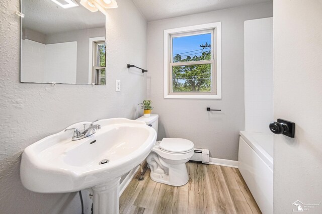2930 Spielman Rd, Adrian, MI 49221 - full bath with a baseboard radiator, wood finished floors, toilet, and baseboards