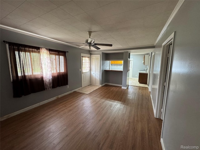 6194 Wilson Dr, Waterford, MI 48329 - spare room featuring crown molding, wood finished floors, a ceiling fan, and baseboards