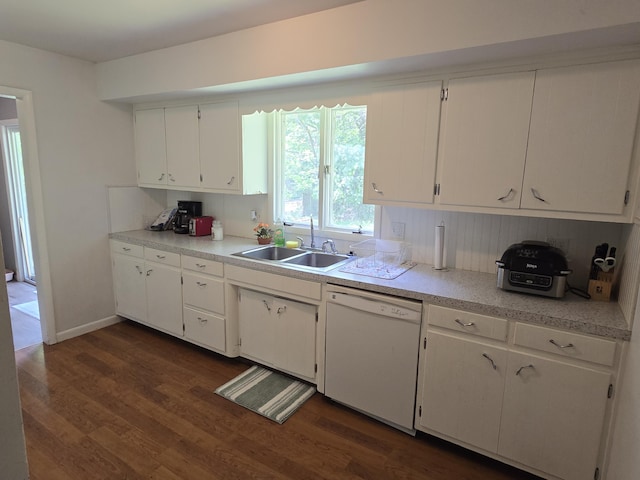 510 E Lewis St, Whitehall, MI 49461 - kitchen with white dishwasher, a sink, dark wood finished floors, white cabinets, and light countertops
