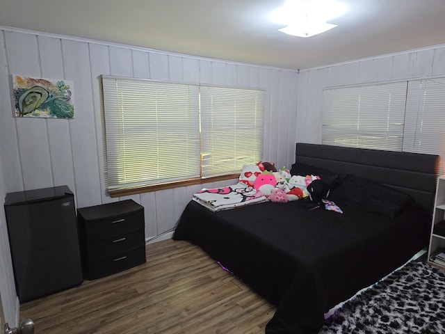 510 E Lewis St, Whitehall, MI 49461 - bedroom with wood finished floors, a decorative wall, and refrigerator