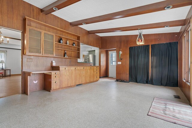 528 Glendale Blvd, Parchment, MI 49004 - kitchen featuring wood walls, stainless steel fridge, beamed ceiling, open shelves, and decorative light fixtures
