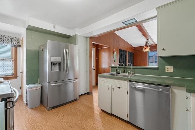 528 Glendale Blvd, Parchment, MI 49004 - kitchen with appliances with stainless steel finishes, a sink, light wood finished floors, dark countertops, and white cabinets