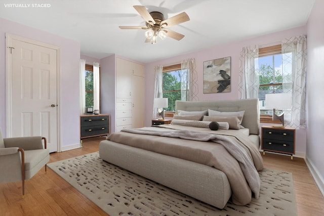 528 Glendale Blvd, Parchment, MI 49004 - bedroom with light wood-style flooring, baseboards, and ceiling fan
