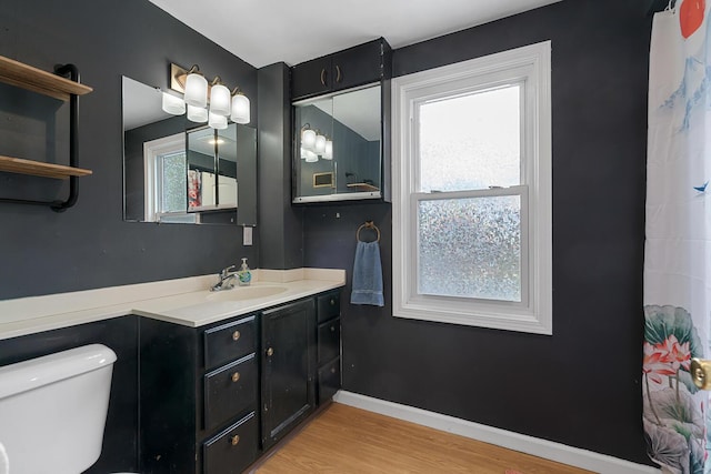 528 Glendale Blvd, Parchment, MI 49004 - bathroom with toilet, wood finished floors, vanity, and baseboards