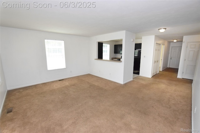 218 E Wood St, Flint, MI 48503 - empty room with light colored carpet and baseboards