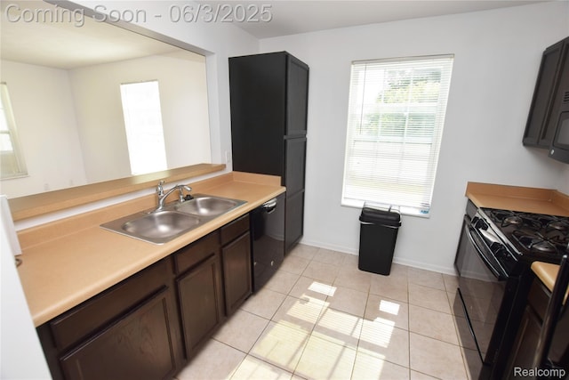 218 E Wood St, Flint, MI 48503 - kitchen featuring a sink, black appliances, light countertops, baseboards, and light tile patterned floors