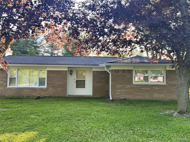 205 Sterling Dr, Lapeer, MI 48446 - view of front of home featuring brick siding, a front lawn, and a chimney
