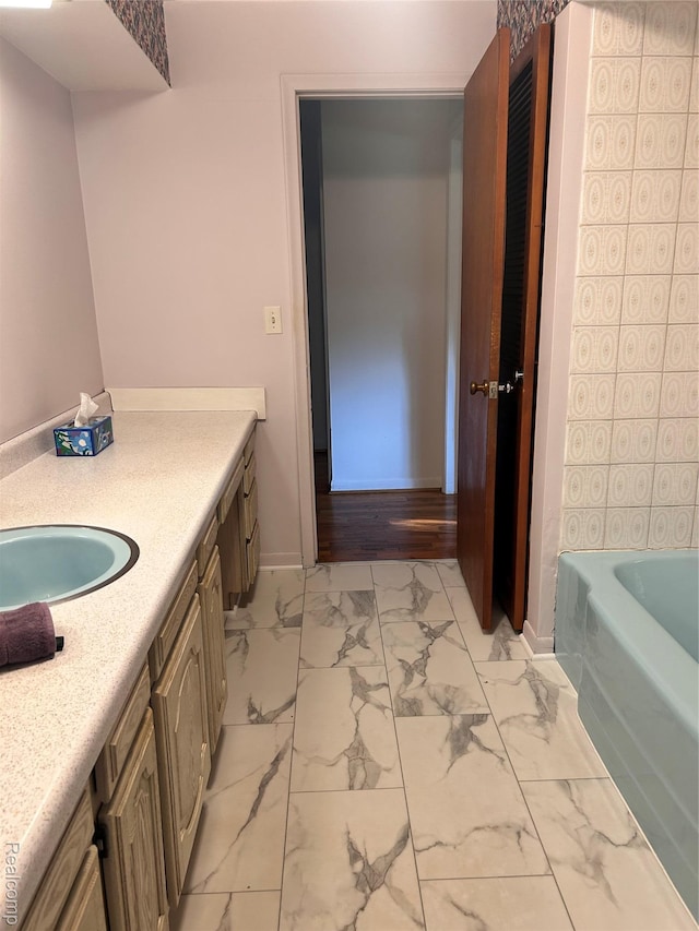 205 Sterling Dr, Lapeer, MI 48446 - full bath with marble look tile flooring, vanity, and baseboards