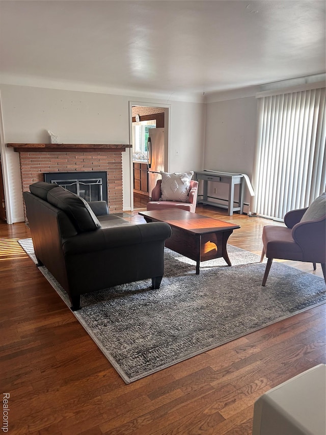 205 Sterling Dr, Lapeer, MI 48446 - living area featuring a brick fireplace and wood finished floors