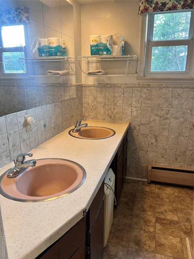 205 Sterling Dr, Lapeer, MI 48446 - bathroom with a baseboard radiator, tile walls, and double vanity