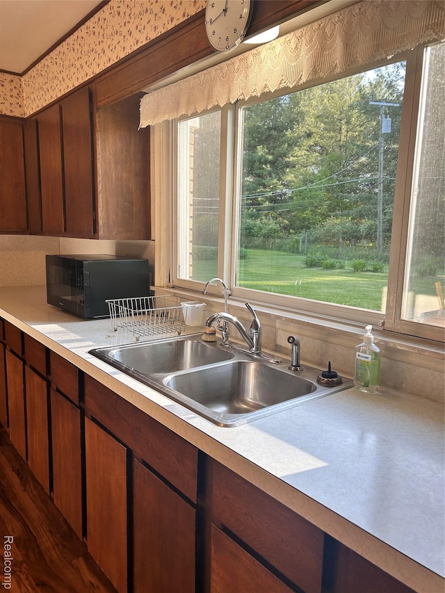 205 Sterling Dr, Lapeer, MI 48446 - kitchen with black microwave, a sink, and healthy amount of natural light
