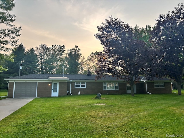 205 Sterling Dr, Lapeer, MI 48446 - single story home with a garage, concrete driveway, a front lawn, and brick siding