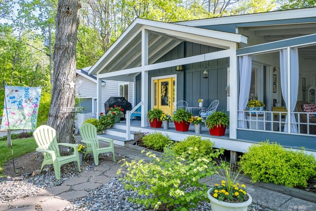 11198 E Royal Rd, Canadian Lakes, MI 49346 - entrance to property featuring board and batten siding and covered porch