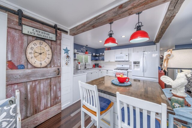 11198 E Royal Rd, Canadian Lakes, MI 49346 - kitchen featuring white appliances, a sink, a barn door, white cabinets, and dark wood-type flooring