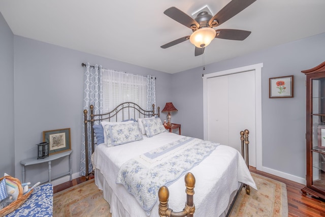 11198 E Royal Rd, Canadian Lakes, MI 49346 - bedroom featuring a closet, baseboards, wood finished floors, and a ceiling fan