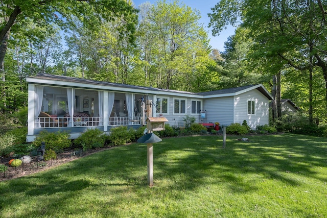 11198 E Royal Rd, Canadian Lakes, MI 49346 - view of front facade featuring a sunroom and a front yard