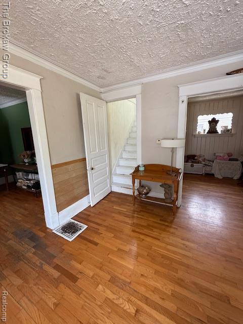 619 W Barnes Ave, Lansing, MI 48910 - interior space featuring ornamental molding, wood finished floors, and a textured ceiling