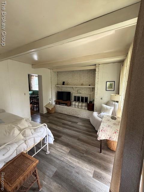 619 W Barnes Ave, Lansing, MI 48910 - bedroom with beamed ceiling, wood finished floors, and a fireplace