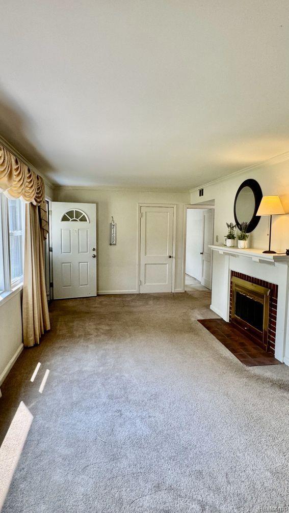 612 Cressfield Ln, Ann Arbor, MI 48103 - unfurnished living room featuring a fireplace, carpet floors, and baseboards