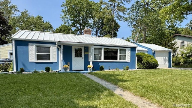612 Cressfield Ln, Ann Arbor, MI 48103 - view of front of home featuring a chimney, a front yard, a garage, a standing seam roof, and metal roof