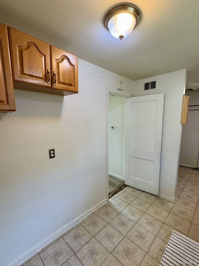 612 Cressfield Ln, Ann Arbor, MI 48103 - laundry room with baseboards and light tile patterned floors