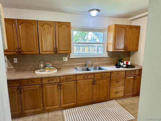 612 Cressfield Ln, Ann Arbor, MI 48103 - kitchen featuring a sink, brown cabinets, and light tile patterned floors