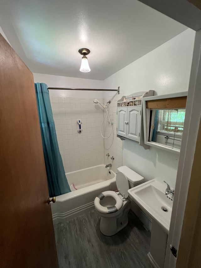 7530 Warren Woods Rd, Three Oaks, MI 49128 - full bathroom featuring wood finished floors, shower / bath combo with shower curtain, and toilet