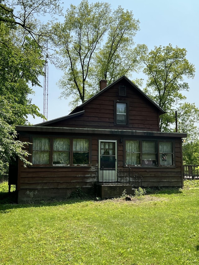 7530 Warren Woods Rd, Three Oaks, MI 49128 - view of front of house with a chimney and a front lawn
