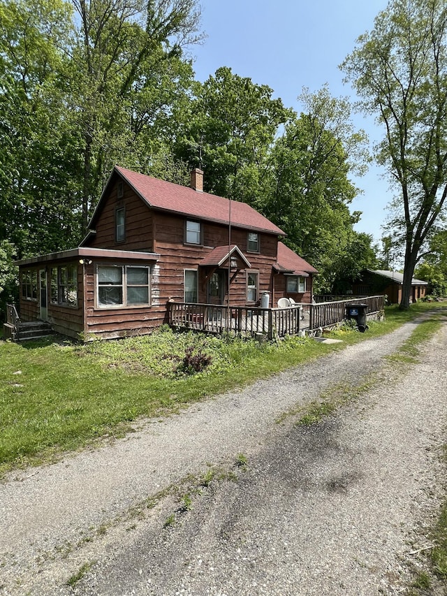 7530 Warren Woods Rd, Three Oaks, MI 49128 - view of front of property with a chimney, driveway, and a deck